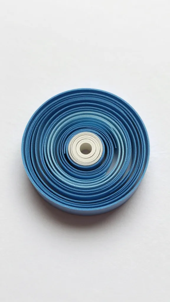 closeup of a single paper quilling coil in progress