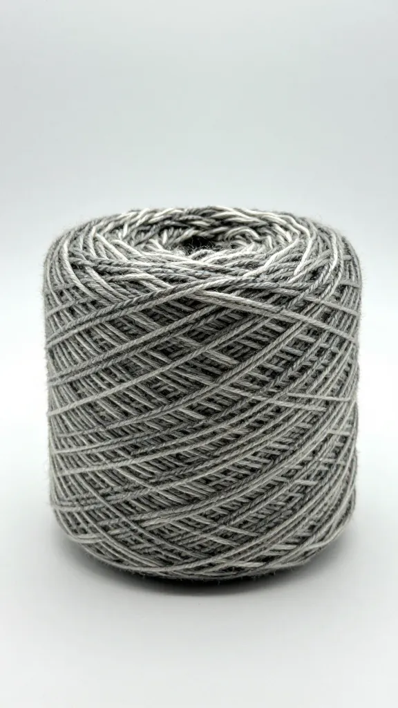 Closeup of a single skein of variegated yarn on a plain backdrop