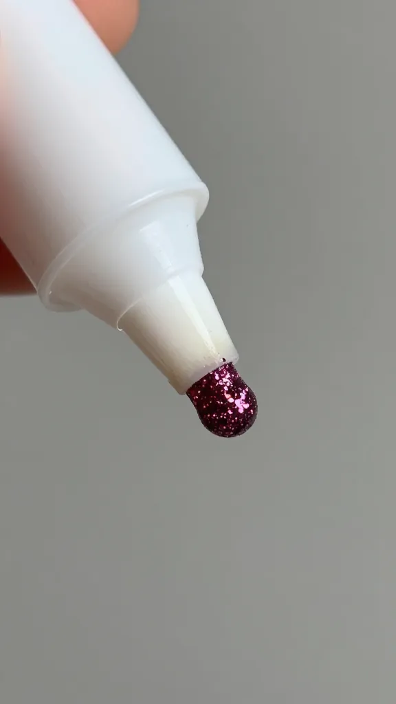 closeup of a single glue stick applying glitter