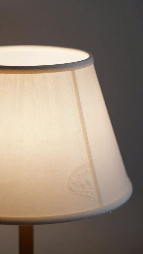 single seashell lampshade closeup with soft coastal light